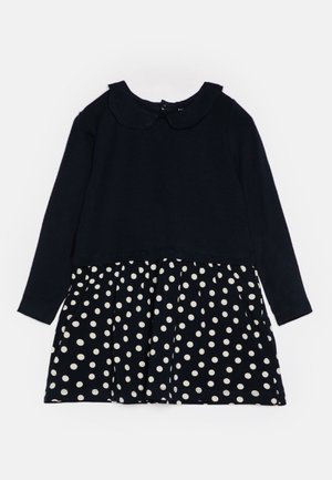 Robe bleu marine à manches longues avec un col arrondi et une jupe blanche à pois pour enfant.