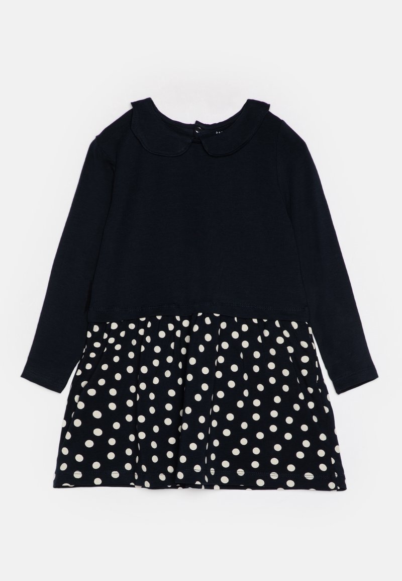 Robe bleu marine à manches longues avec un col arrondi et une jupe blanche à pois pour enfant.