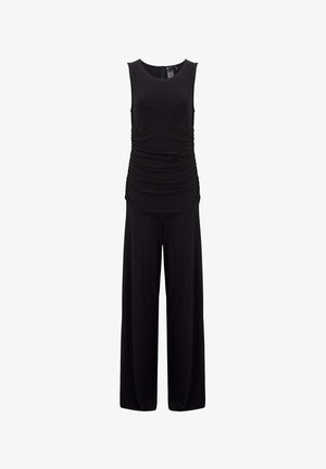 Combinaison noire sans manches avec une taille ajustée froncée et un pantalon à jambes larges, avec un col rond et une fermeture éclair au dos.
