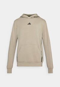 Beige hoodie met een zwart logo, voorzak met kangoeroe-opening, lange mouwen en geribde boorden, gemaakt van zacht materiaal.