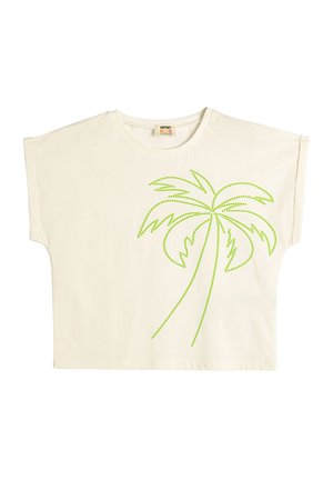 Cremfarbendes T-Shirt mit kurzen, weiten Ärmeln. Auf der Vorderseite befindet sich ein Design einer Palme mit grünem gepunktetem Umriss. Aus weichem Baumwollstoff.