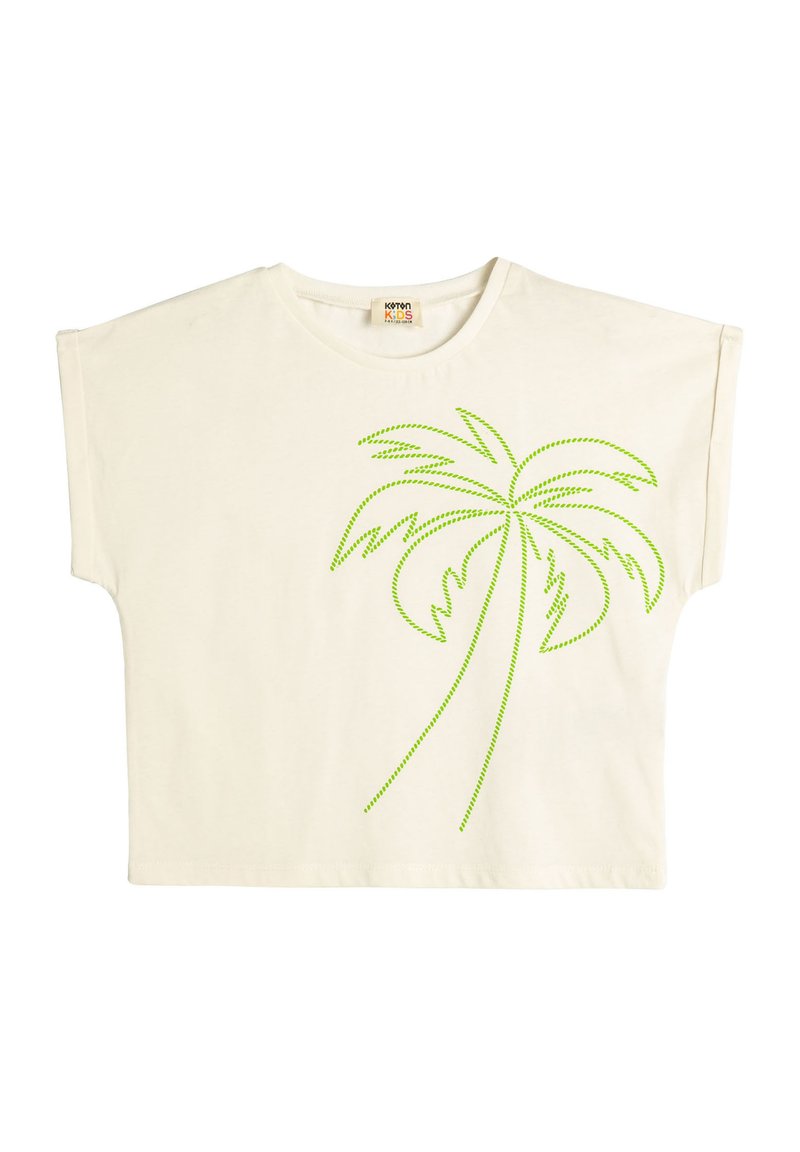 Camiseta de color crema con mangas cortas y anchas. Presenta un diseño de palmera con contorno de puntos verdes en la parte delantera. Tejido de algodón suave.