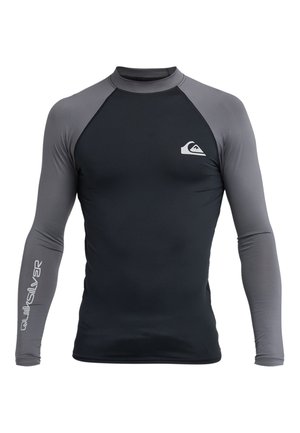 Top anti-éruption à manches longues en noir et gris, avec une texture lisse, un col rond, et le logo Quiksilver sur la poitrine et la manche.