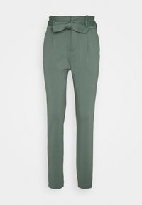 High-waist green trousers with tapered legs and a matching fabric belt tied in a bow at the waist.