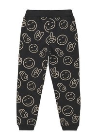 Zwarte joggingsbroeken met een patroon van lichtbeige glimlachende gezichten, handgebaren en vredestekens; elastische tailleband en boorden.