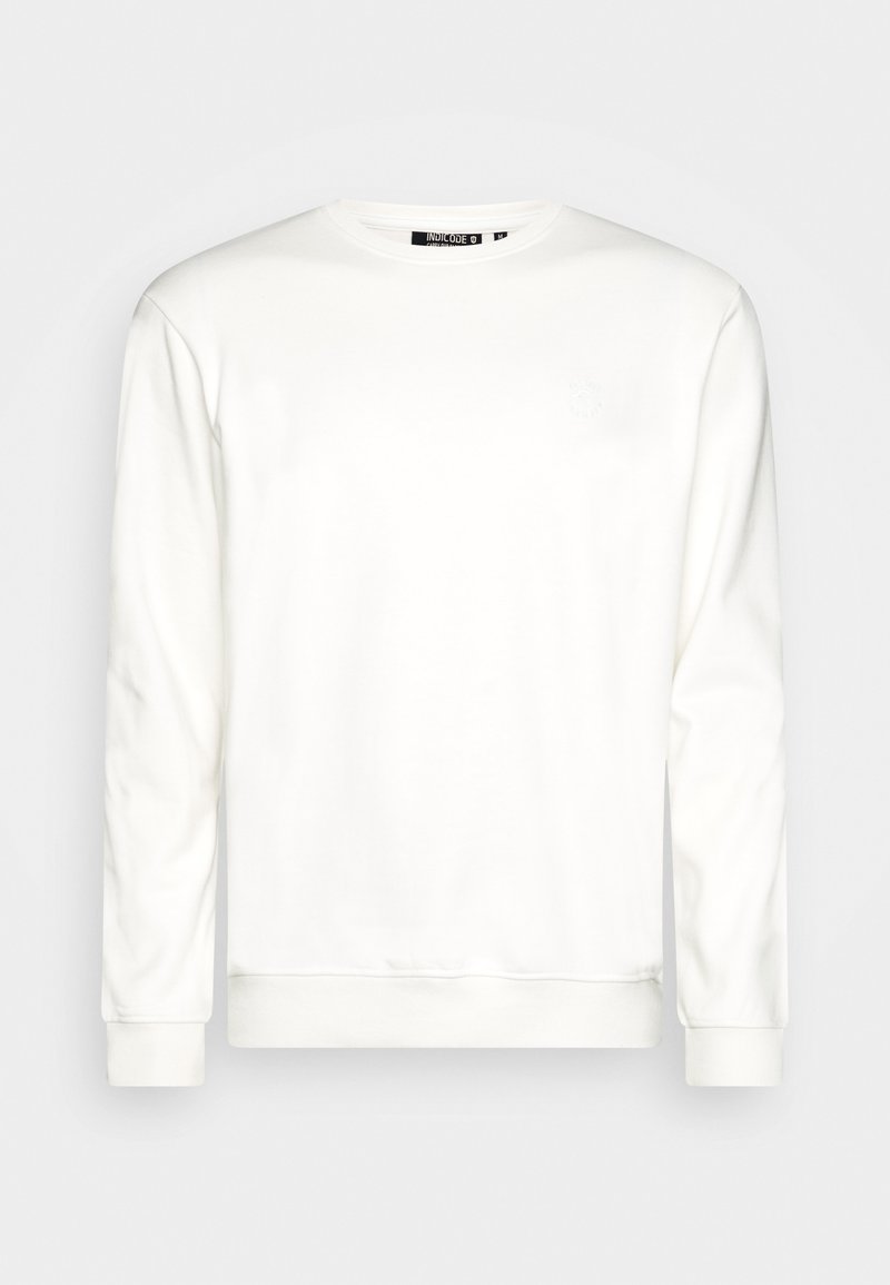 Sweatshirt blanc à manches longues, col rond et poignets côtelés. Présente un petit logo ton sur ton sur la poitrine. Matière en mélange de coton doux.