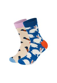 Two pairs of cotton socks: one beige with carrot patterns and pastel pink cuff, the other blue with white bunnies and orange accents.