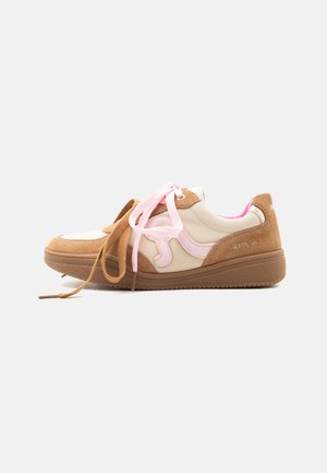 Pair of beige and brown sneakers with pink accents, mixed materials, and mismatched laces in brown and pink on white background.