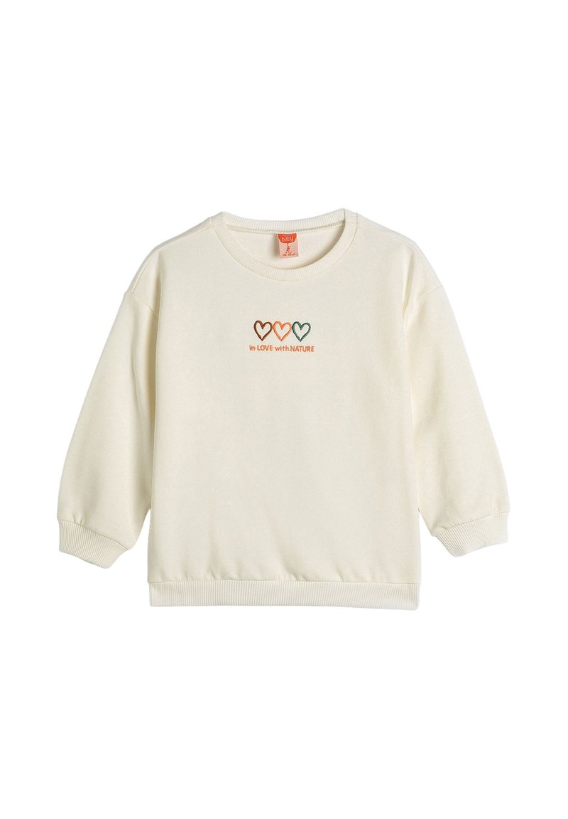Sudadera crema con cuello redondo y mangas largas de corte amplio. Presenta gráficos de corazones en marrón, naranja y verde, así como bordado de texto.