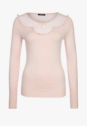 Suéter rosa de manga larga con un cuello de volantes y lunares. Tela suave, diseño ajustado y textura acanalada. Sin adornos adicionales.