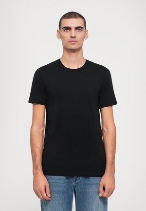 Black cotton T-shirt with a crew neck and short sleeves, featuring a simple, smooth texture. Worn with light blue jeans.