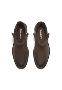 Brune lær ankle boots med blødt fleecefor, rund tå og lynlås lukning i siden. Timberland logo på indersålen.