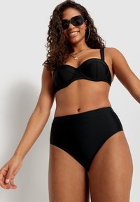 Black bikini set featuring a structured underwire top with seamless cups and high-waisted bottoms, made from smooth, elastic fabric.