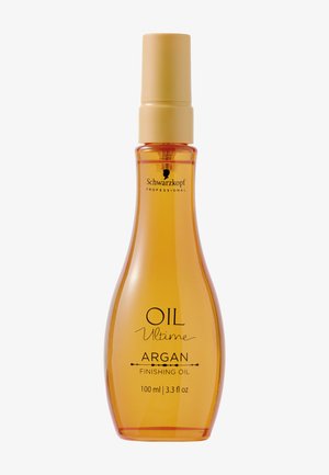 Huile de finition à l'argan dans une bouteille transparente en forme de goutte avec un bouchon crème. Le liquide est jaune doré, étiqueté "OIL Ultimate".