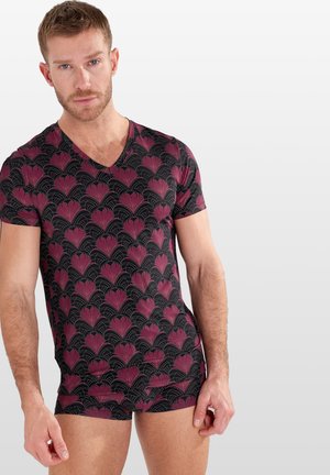 Schwarzes V-Ausschnitt-Shirt mit wiederholtem pinkem Blumenmuster, geschwungenen Linien, kurzen Ärmeln und tailliertem Schnitt. Weicher Stoff.