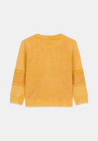 Sudadera amarilla con superficie texturizada, cuello y puños acanalados. Presenta parches en los codos para un detalle adicional. Vista trasera.