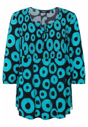 Blouse noire avec un motif de cercles turquoise, décolleté rond, manches courtes et un détail noué au col. Tissu doux.