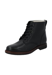 Botín negro de cuero con cordones hasta el tobillo, con welt marrón, suela negra y forro de lana blanca visible en el borde superior.