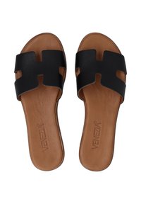 Black leather slide sandals with an open-toe design, featuring a cut-out geometric pattern and tan leather insoles.