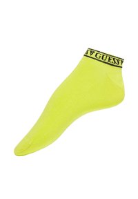 Chaussette courte jaune néon avec un logo "GUESS" noir sur le revers. Fabriquée à partir d'un matériau lisse et extensible pour le confort et l'ajustement.