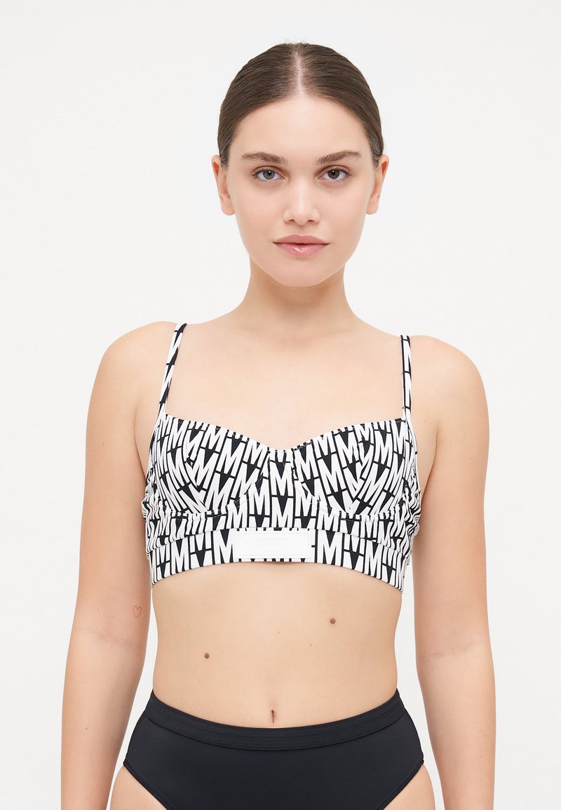 Black and white printed bralette with wide straps, featuring large letter patterns, gathered fabric around the bust, and a solid band.