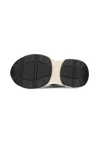 Suela de zapatilla negra con goma texturizada, que presenta una entresuela beige, secciones de agarre con patrón y detalles moldeados para tracción.