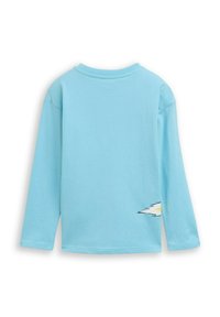 Long-sleeve light blue shirt made of cotton, featuring a stylized lightning bolt graphic on the left side near the hem.