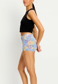 Boxers à motifs floraux de couleur bleu clair, ornés de différentes fleurs colorées. Tissu extensible et doux avec une taille confortable.