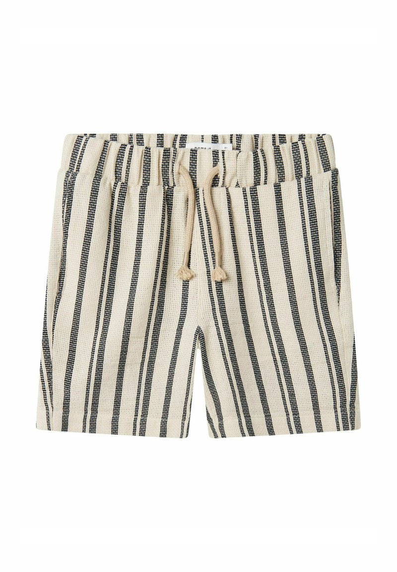 Beige shorts med vertikale sorte striber, elastisk talje, snor og to sidelommer. Stoffet ser struktureret og vævet ud.