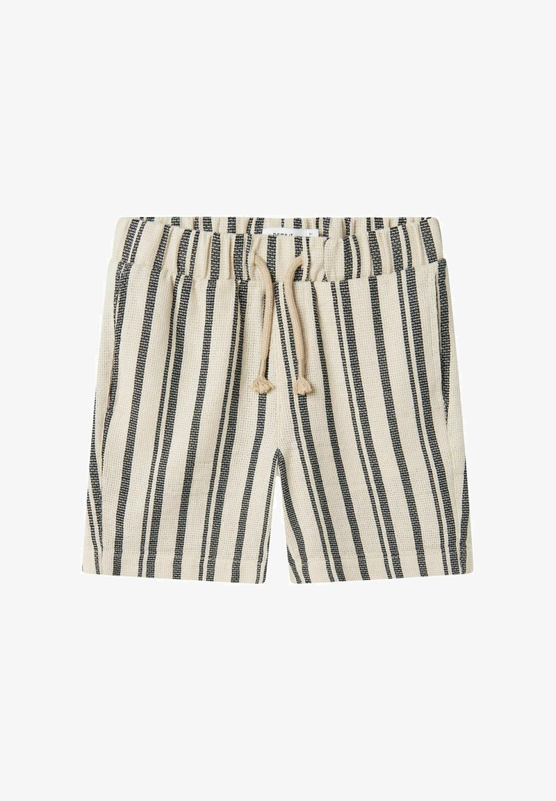 Shorts beiges avec des rayures noires verticales, taille élastique, cordon de serrage et deux poches latérales. Le tissu semble texturé et tissé.