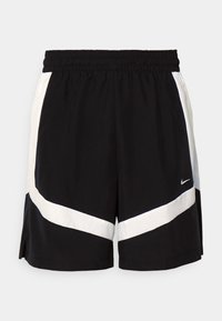 Black athletic shorts with an elastic waistband, featuring white diagonal stripe accents and split side hems. Made from lightweight fabric.
