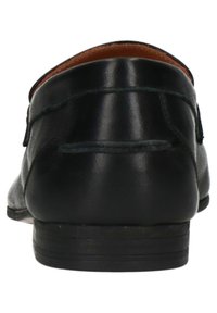 Black leather loafer with a smooth finish, rounded toe, and minimal stitching. Features a low, stacked heel and brown inner lining.