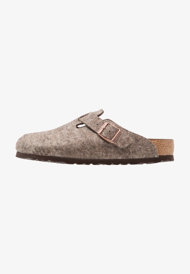 Brown felt clogs with a cork footbed, adjustable buckle, and open back. Textured surface and rubber sole for grip. Classic slip-on design.
