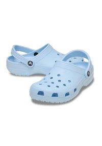 Light blue foam clogs with ventilation holes, raised edges, and a back strap. Textured sole for grip and rounded toe design.
