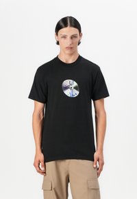Black cotton t-shirt featuring a circular graphic print resembling a CD with colorful graffiti-style text at the center. Short sleeves, crew neck.