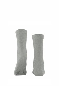Chaussettes en coton gris avec une texture lisse, de longueur mi-mollet et des bords côtelés. Présente un logo imprimé sur la semelle.