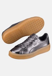 Baskets argentées métalliques avec une finition brillante, languette rembourrée et semelle extérieure en caoutchouc naturel avec un motif en losange. Design à lacets avec détail de marque.