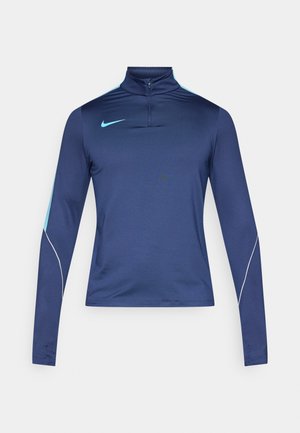 Maglia a maniche lunghe color blu navy con zip a quartino, caratterizzata da accenti azzurri chiari e una banda laterale bianca, realizzata in un tessuto liscio ed elastico.