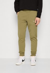 Calvin Klein MICRO LOGO - Treniņtērpa apakšdaļas - delta green