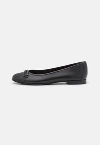 Black leather ballet flat with rounded toe, decorative buckle detail at the front, low heel, and smooth texture.