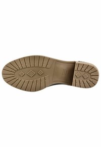 Semelle de chaussure en caoutchouc brun clair avec des motifs texturés, comprenant des rainures et des formes en diamant, offrant traction et soutien.