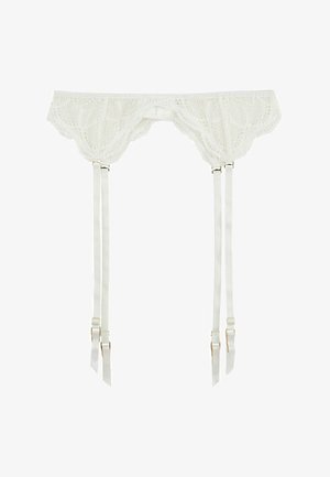 Jarretelle en dentelle blanche avec bords festonnés, équipée de quatre bretelles en satin ajustables et de ferrures dorées. Motif en dentelle détaillé sur toute la surface.