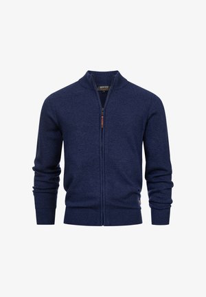 Granatowy sweter zapinany na zamek, wykonany z dzianiny, z podwyższonym kołnierzem, ściągaczami na rękawach oraz skórzaną pętelką przy suwaku.