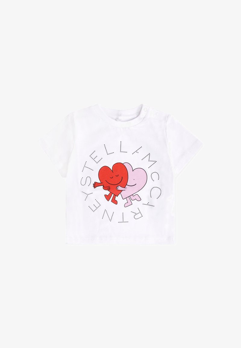 T-shirt en coton blanc avec un graphique de cœur rouge et rose affichant des visages souriants, entouré du nom de la marque en lettres à points.