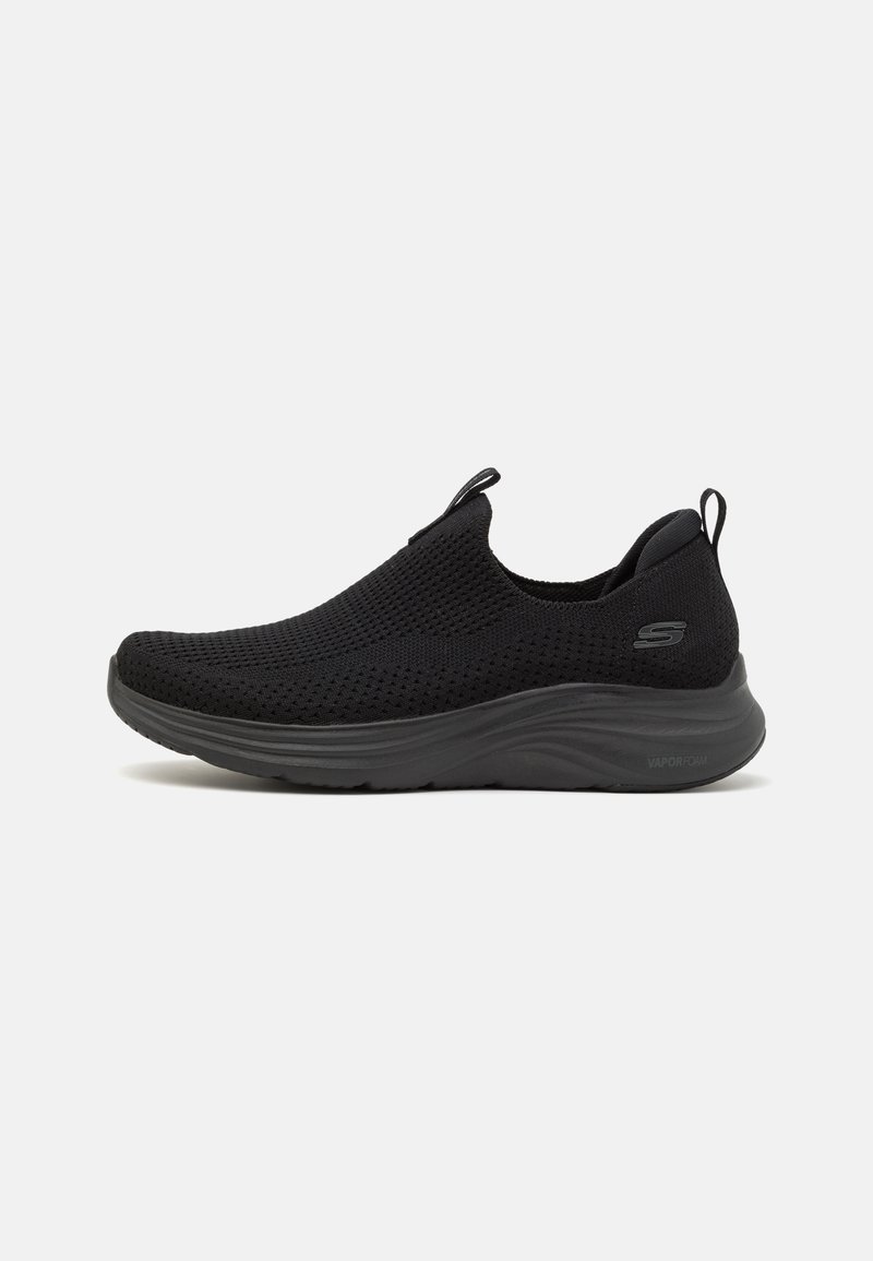 Black slip-on sneaker with a breathable mesh upper, padded collar, and lightweight EVA sole. Features a textured surface and minimal branding.