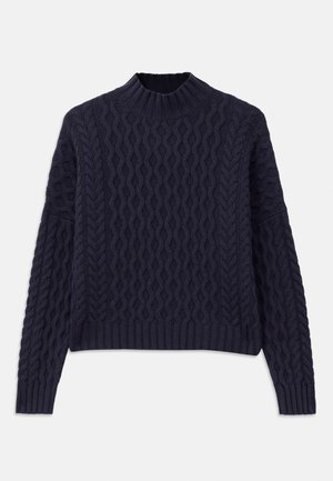 Jersey de color azul marino de punto con un patrón de olas texturizado, cuello alto y puños y dobladillo acanalados para un ajuste estructurado.