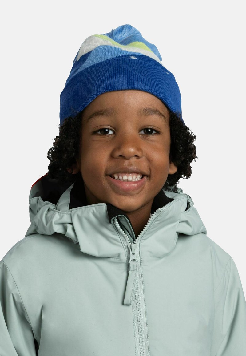Blue knitted hat with a multi-colored striped pattern and a pom-pom on top, worn with a light gray hooded jacket featuring a zipper.