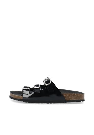 Black patent slide sandal with three adjustable buckles, cork midsole, and flat rubber outsole. Smooth texture and modern design.