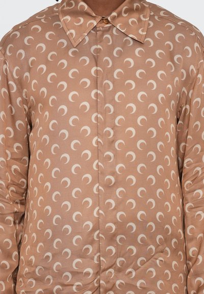 Brown shirt with a smooth satin finish, featuring a repetitive crescent moon pattern in cream, a classic collar, and button closure.