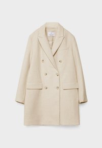 Manteau beige à double boutonnage en mélange de laine avec revers crantés, six boutons, deux poches avant à rabat et une poche poitrine passepoilée.
